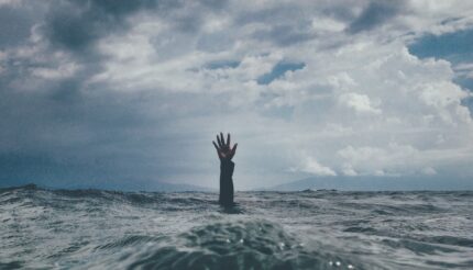 This is a picture of someone sinking and raising a hand in the air for help. It is to symbolise burning out at work and needing help which is what this blog post is for. To stop burnout and to help your business grow and achieve its goals.