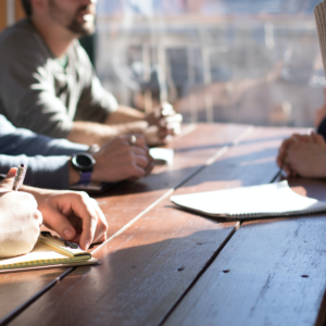 This is a picture of people having a meeting and is to represent meeting with a business coach in order to unleash your businesses' potential