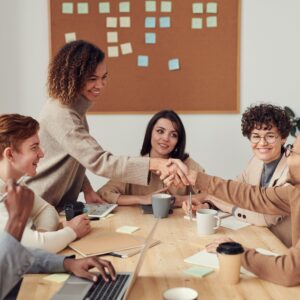 This is a picture of business owners looking happy because they have started the new year strong by following these 8 practical tips