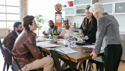 Here is a team looking happy and excited because they have followed the 5 Proven Strategies To Set and Achieve Your Business Goals in 2025